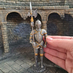 Knight with halberd metal figurine pictured with hand for scale