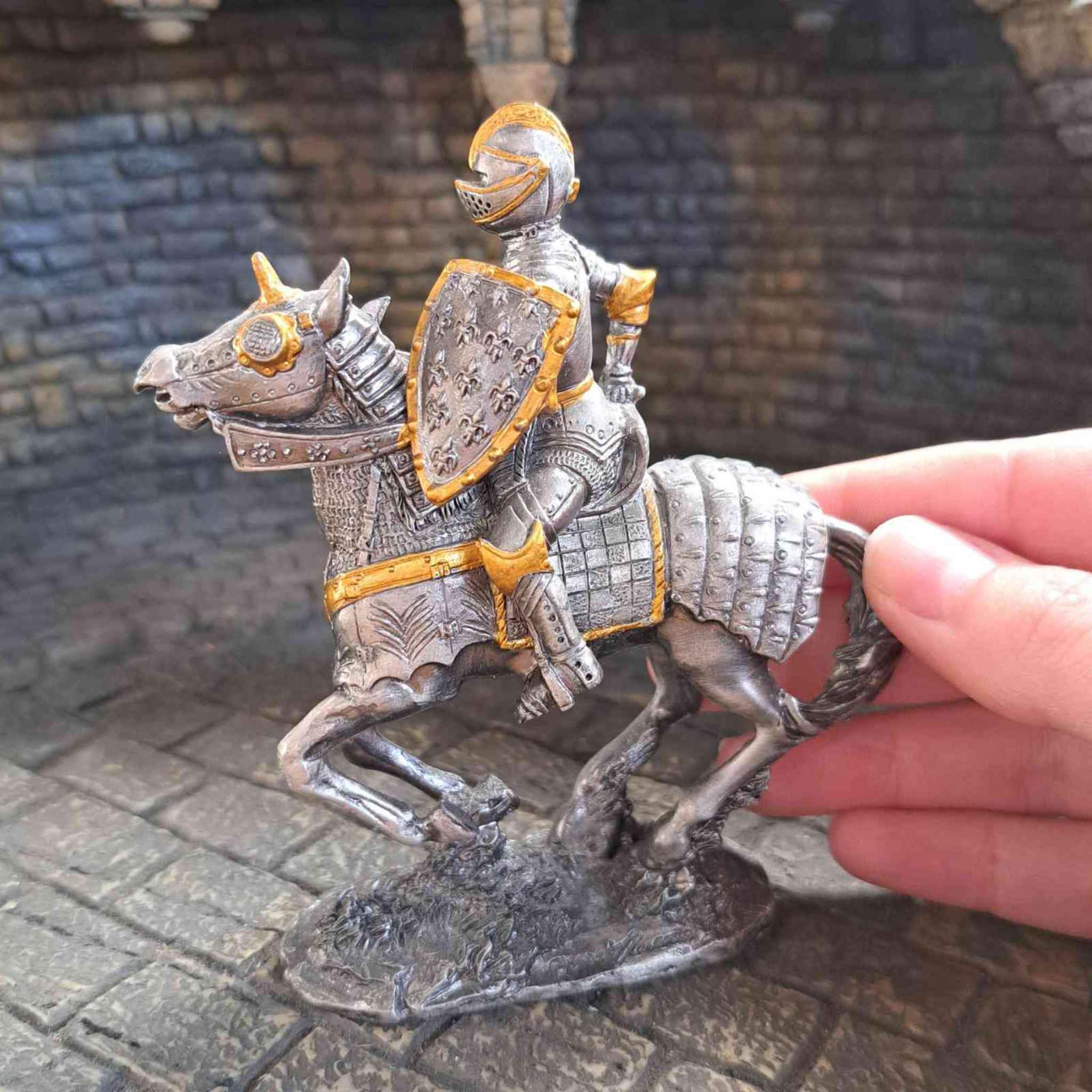 16th century knight on horseback with hand pictured for scale