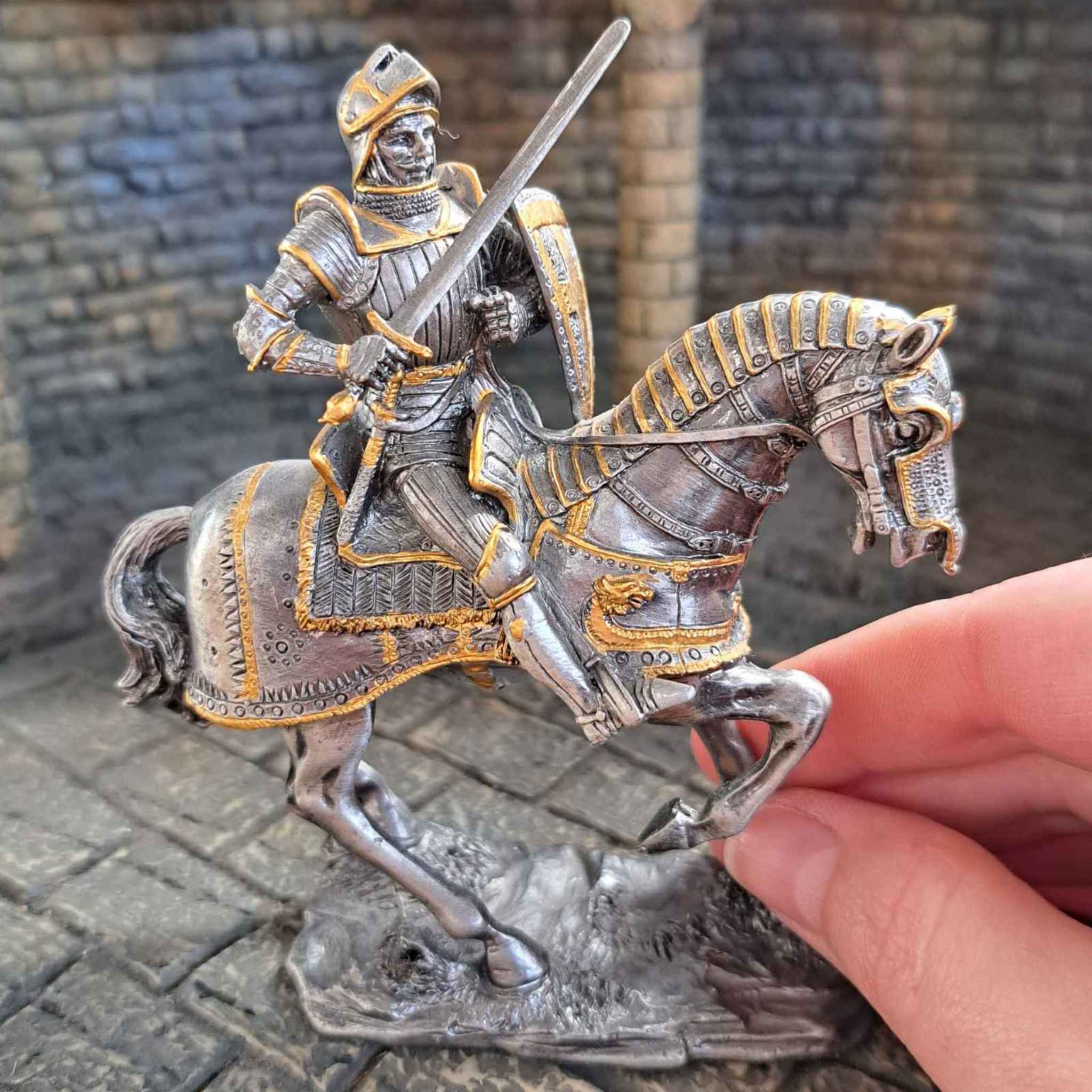 Armoured horse metal knight with hand pictured for scale