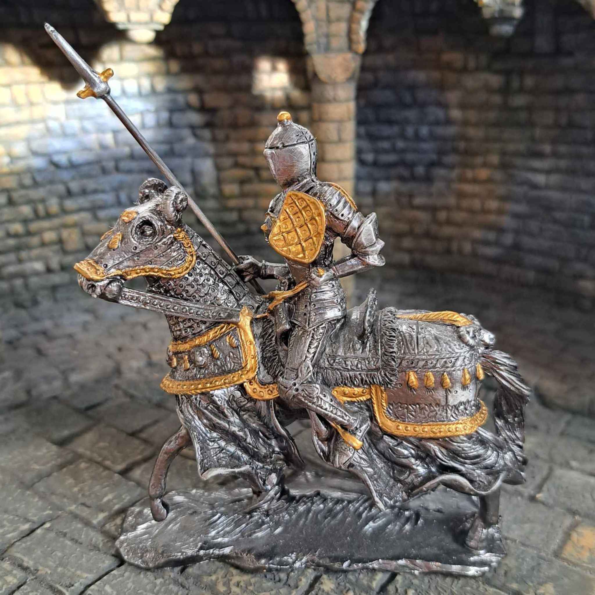 Jousting medieval knight on horseback metal statue close up view