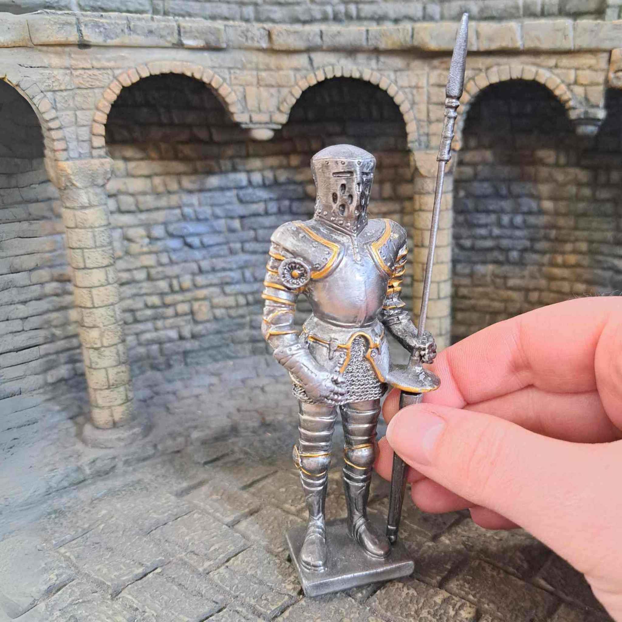 Jousting knight metal model with hand pictured for scale