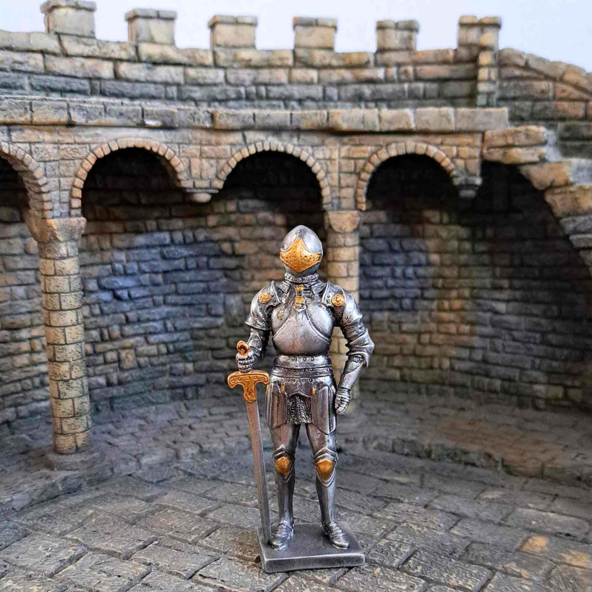 Knight in armour metal statue with medieval background